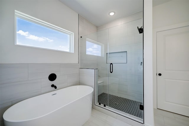 bathroom with tile patterned floors and plus walk in shower