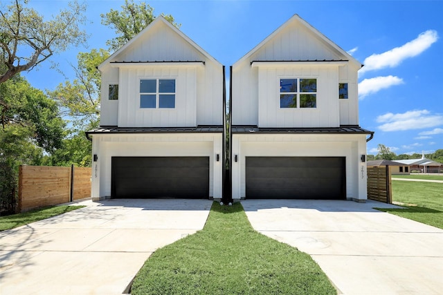 modern farmhouse style home with a front lawn and a garage