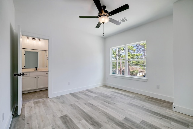 unfurnished bedroom featuring ceiling fan, connected bathroom, light hardwood / wood-style flooring, and sink