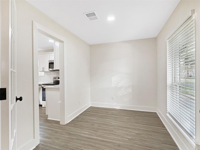 empty room with hardwood / wood-style floors