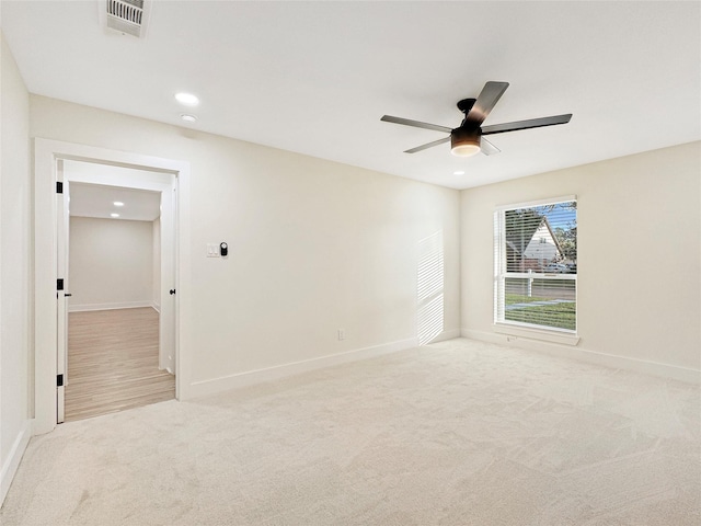 unfurnished room featuring light colored carpet and ceiling fan