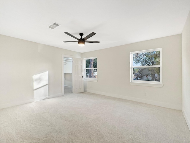 spare room with light carpet and ceiling fan