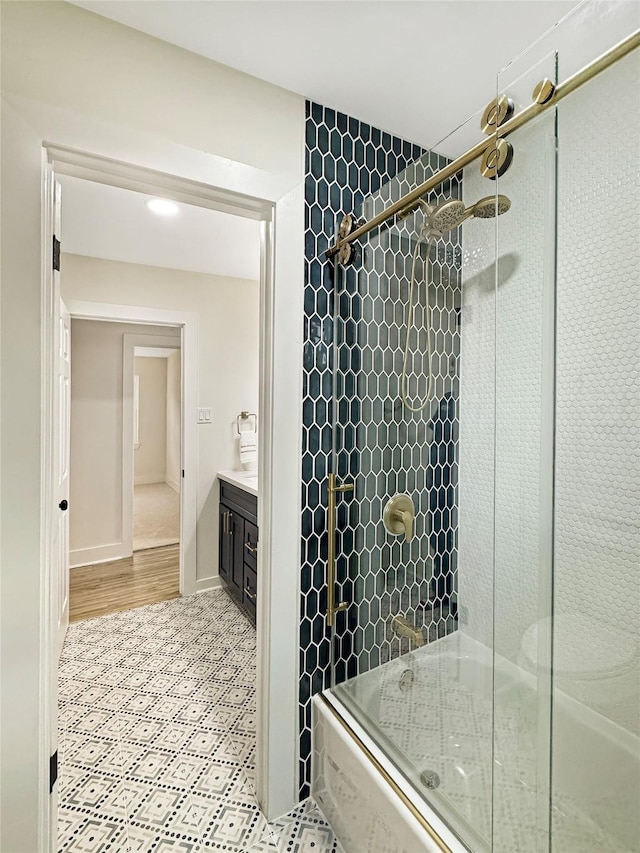 bathroom with enclosed tub / shower combo and vanity