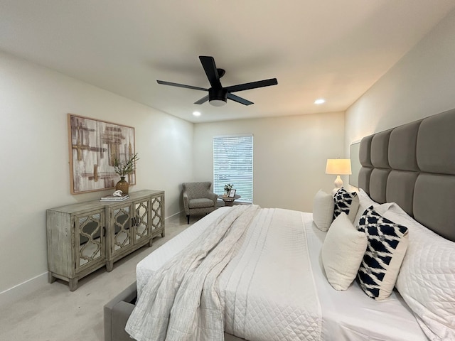 bedroom featuring light colored carpet and ceiling fan