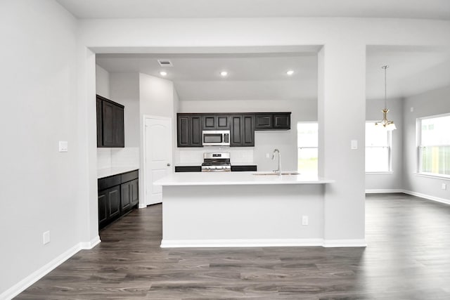 kitchen with dark hardwood / wood-style flooring, sink, pendant lighting, and appliances with stainless steel finishes