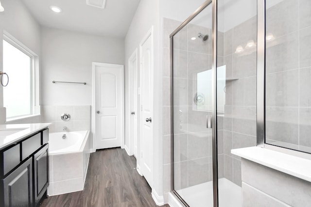 bathroom with separate shower and tub, vanity, and hardwood / wood-style flooring