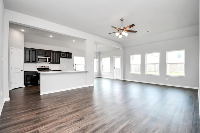 kitchen featuring stainless steel appliances, a wealth of natural light, and dark hardwood / wood-style floors