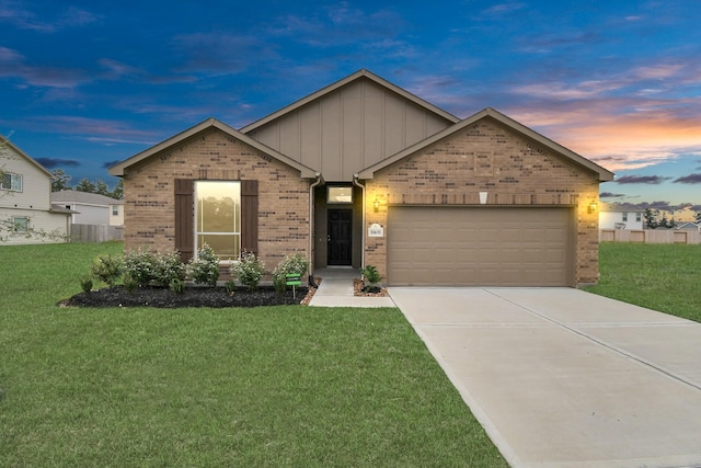 view of front of home featuring a lawn and a garage