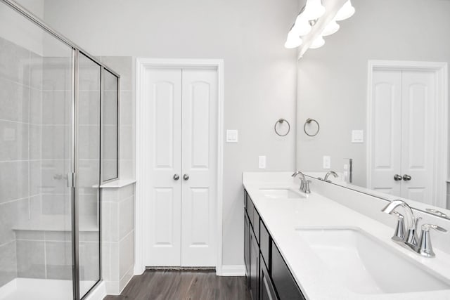 bathroom with vanity, hardwood / wood-style flooring, and walk in shower