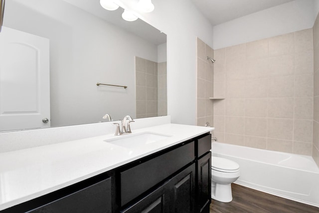 full bathroom featuring toilet, vanity, tiled shower / bath combo, and hardwood / wood-style flooring