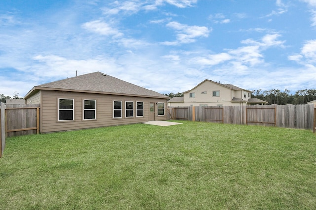 rear view of property featuring a lawn and a patio area