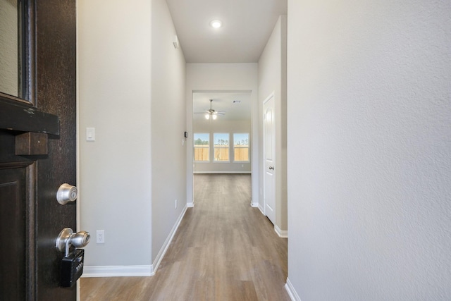 corridor with light hardwood / wood-style floors