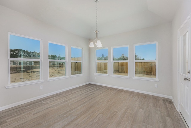 unfurnished sunroom featuring a notable chandelier