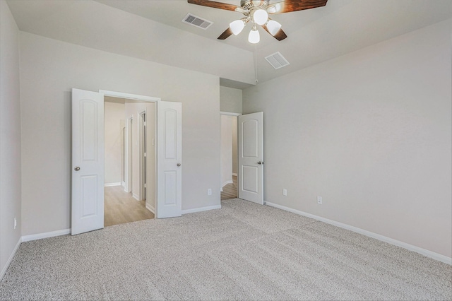 unfurnished bedroom featuring ceiling fan and light carpet