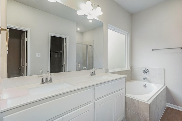 bathroom with vanity, hardwood / wood-style flooring, separate shower and tub, and a notable chandelier