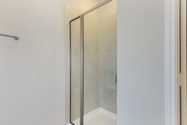 bathroom with a shower with shower door