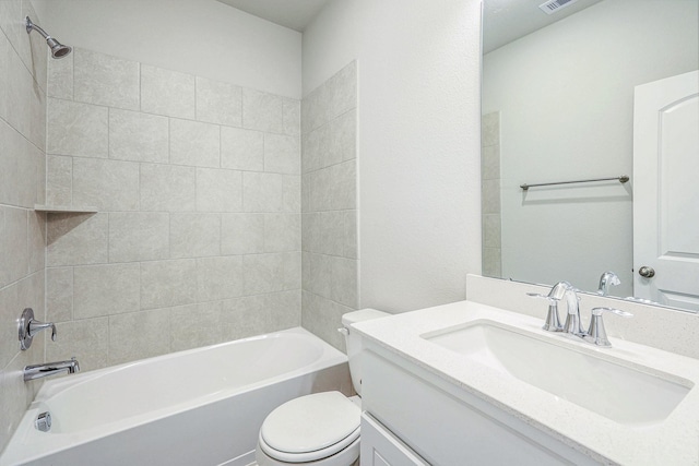 full bathroom with tiled shower / bath combo, toilet, and vanity