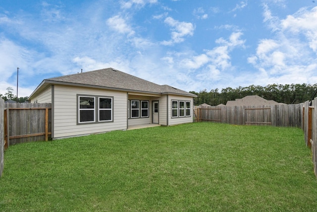 rear view of house with a lawn