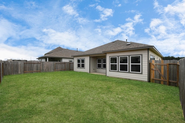 rear view of property with a yard