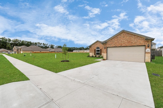 ranch-style home with a garage and a front lawn