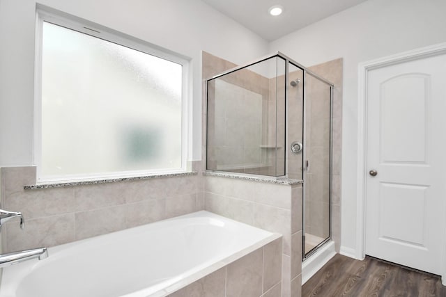 bathroom featuring hardwood / wood-style floors and independent shower and bath