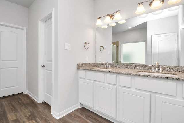 bathroom featuring hardwood / wood-style floors, vanity, and an enclosed shower