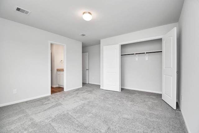 unfurnished bedroom featuring carpet floors and a closet