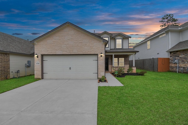 view of front of house featuring a garage and a yard