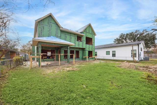 rear view of house featuring a yard and cooling unit