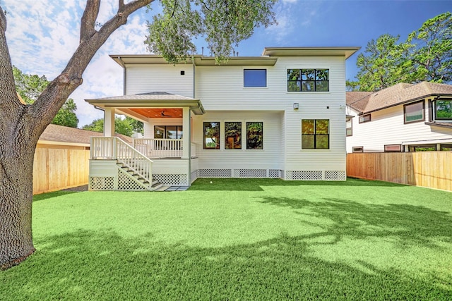 rear view of property with a lawn