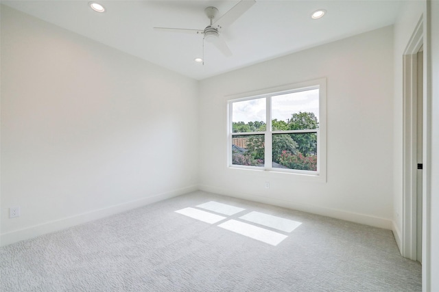 unfurnished room with ceiling fan and light colored carpet