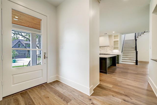 foyer entrance with light hardwood / wood-style flooring