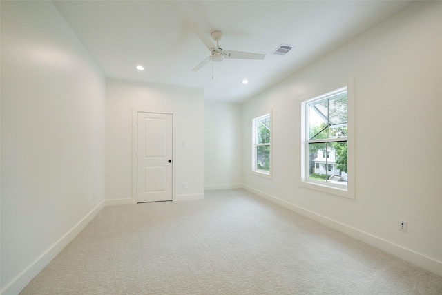 empty room with ceiling fan and light colored carpet