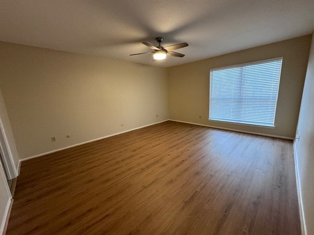 unfurnished room with hardwood / wood-style floors and ceiling fan