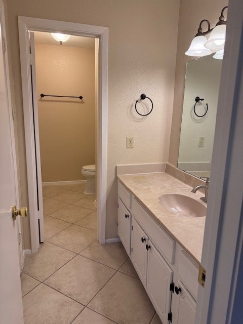 bathroom featuring tile patterned flooring, vanity, and toilet