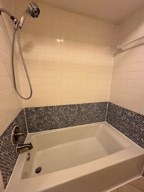 bathroom featuring tile patterned flooring and tiled shower / bath combo