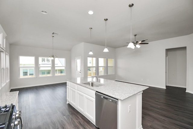 kitchen featuring white cabinetry, sink, dark wood-type flooring, stainless steel appliances, and a kitchen island with sink