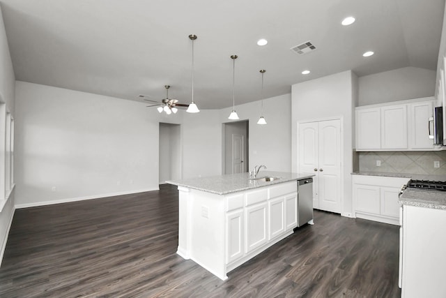 kitchen with ceiling fan, dark wood-type flooring, an island with sink, white cabinets, and appliances with stainless steel finishes