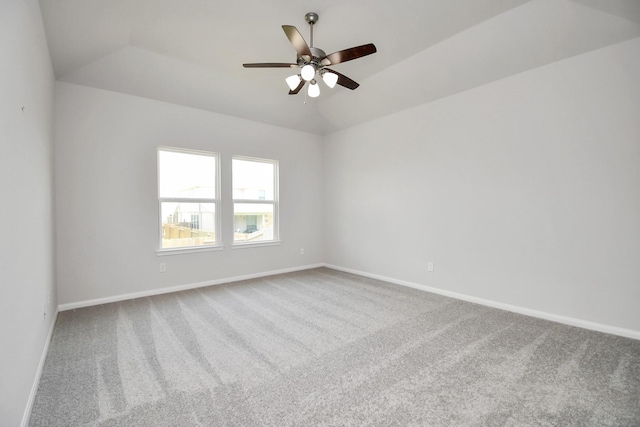 spare room with carpet and vaulted ceiling