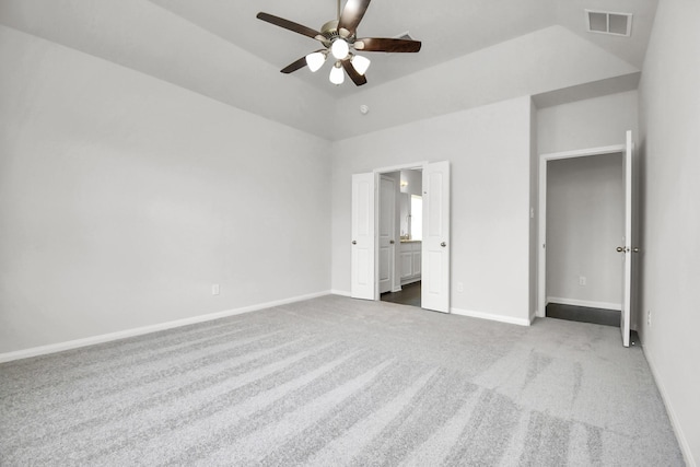 unfurnished bedroom featuring connected bathroom, ceiling fan, carpet, and lofted ceiling