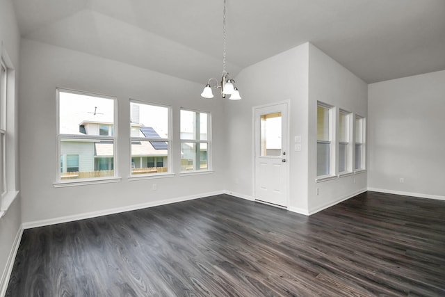 interior space with a chandelier, dark hardwood / wood-style flooring, and lofted ceiling