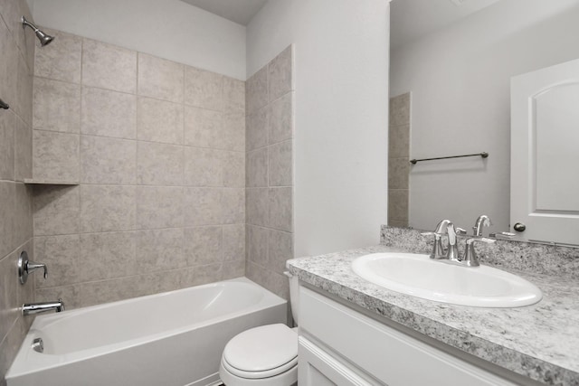 full bathroom featuring vanity, toilet, and tiled shower / bath