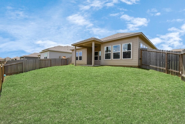 rear view of property with a lawn