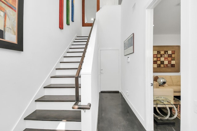 stairway featuring concrete flooring