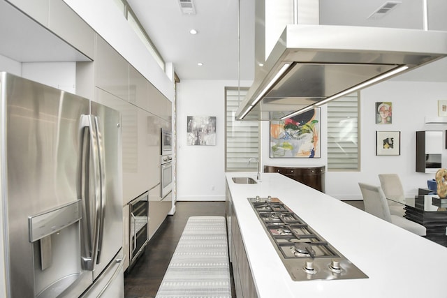 kitchen with sink, beverage cooler, dark hardwood / wood-style floors, and appliances with stainless steel finishes