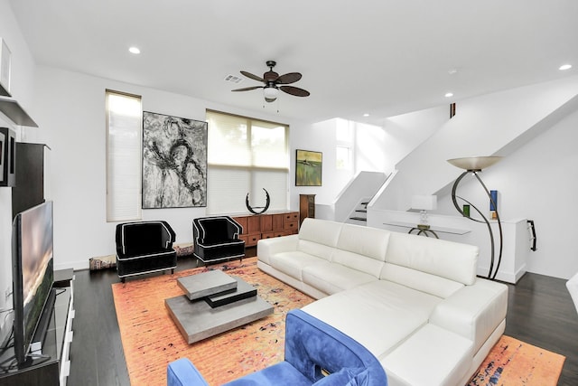 living room with ceiling fan and dark hardwood / wood-style flooring