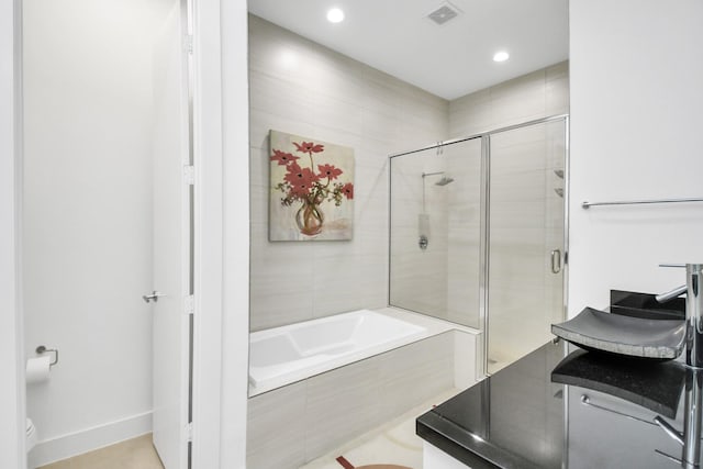 bathroom featuring separate shower and tub