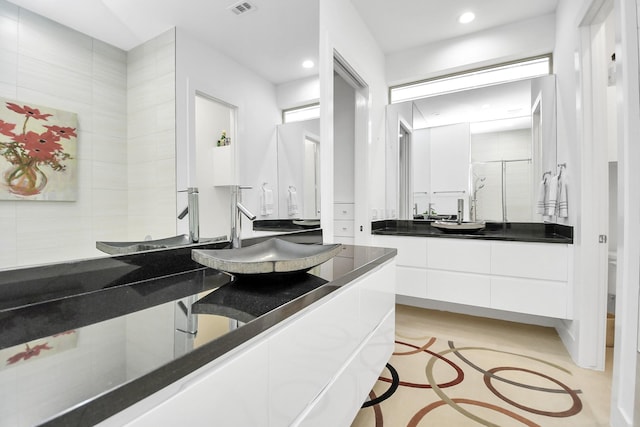 bathroom featuring vanity and walk in shower