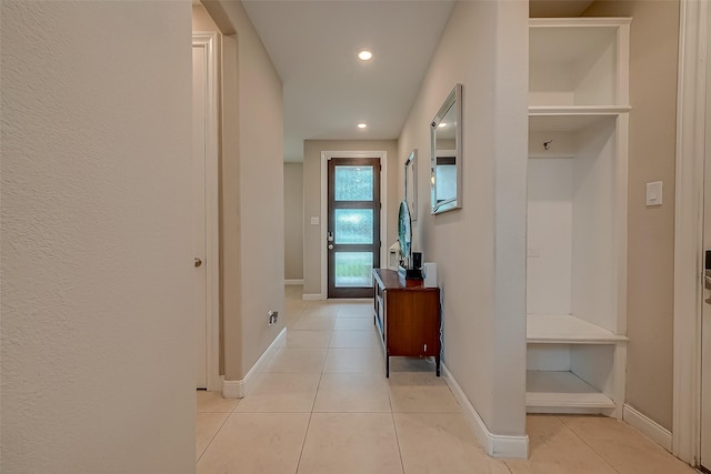 hall with light tile patterned floors