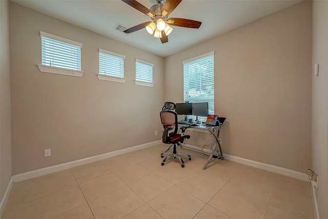 unfurnished office with ceiling fan and light tile patterned floors